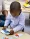 Boy putting together a puzzle