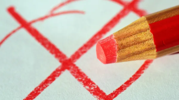 Red pencil with "X" written on paper