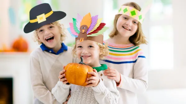 Three children in Thanksgiving attire.