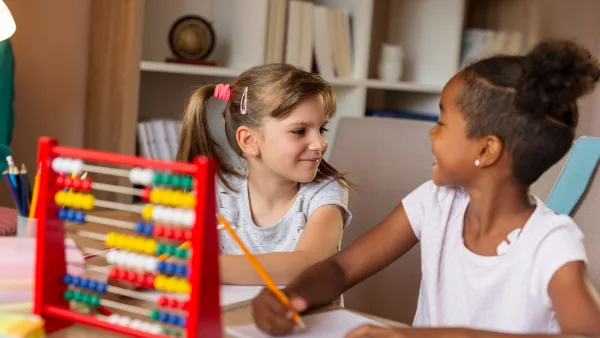 Two girls working on homework together