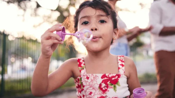 A girl blowing bubbles