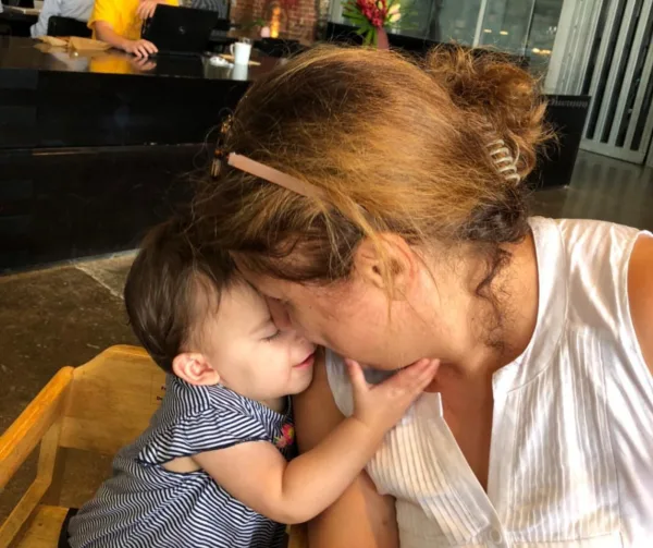 Parent nuzzling toddler